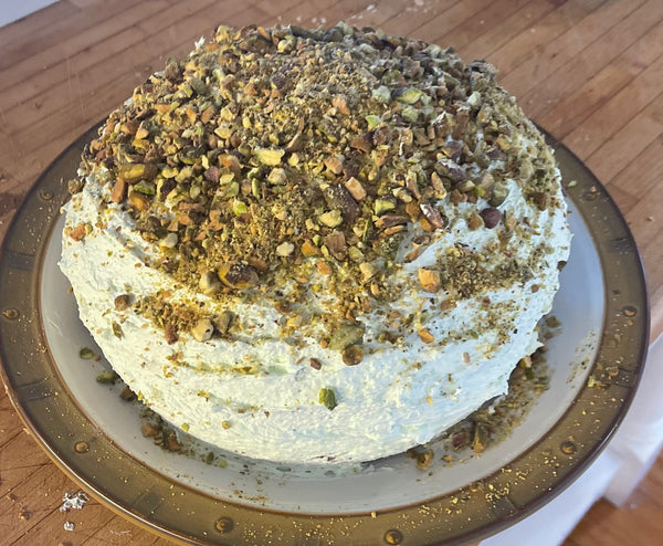 round layer cake topped with chopped pistachios.