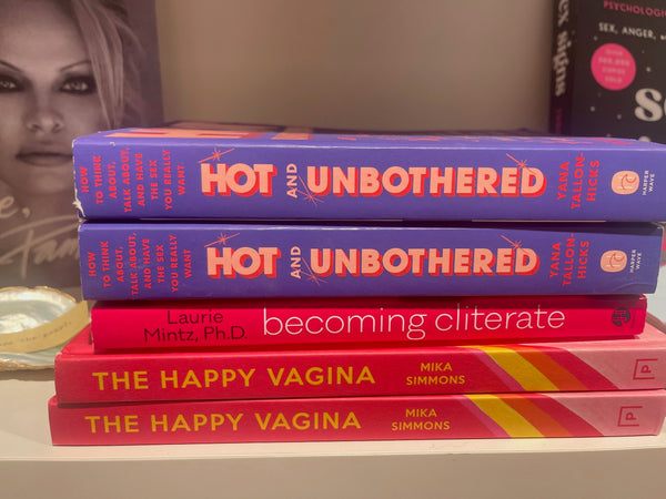a stack of books Hot and Unbothered, Becoming Cliterate and The Happy Vagina