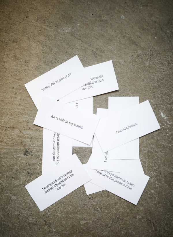 Rectangular cards all spread out on the floor, all with different phrases of gratitude.