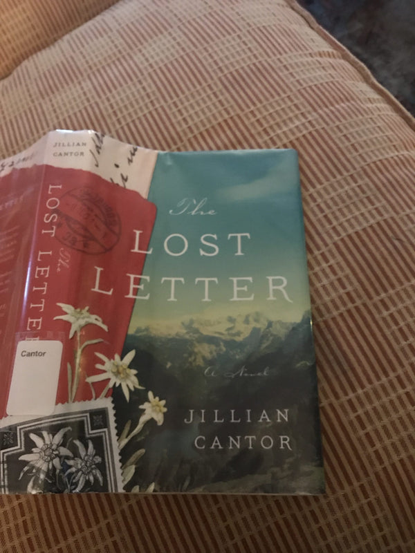 A book cover, 'The Lost Letter' by Jillian Cantor, the cover art decorated by mountains, another image of small delicate flowers, and a postage stamp with the same flowers.