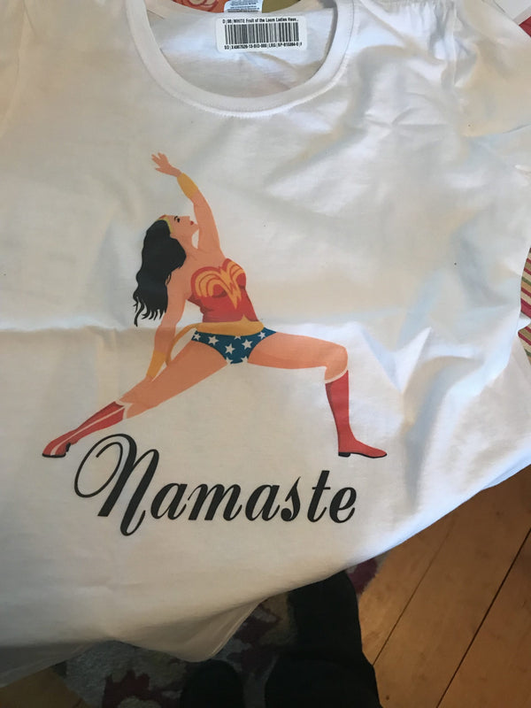 A t-shirt with the words Namaste under Wonder Woman doing a yoga pose.
