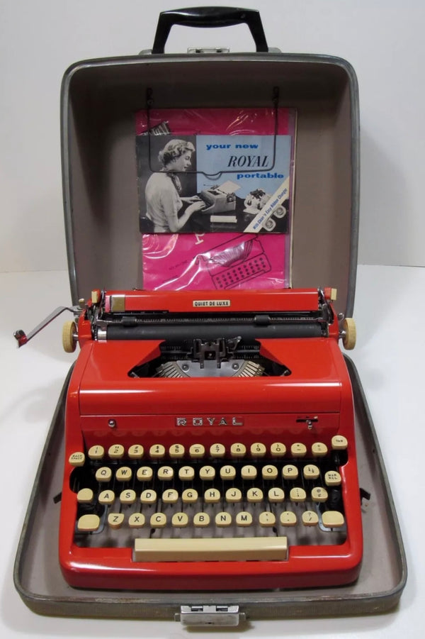 Bright Royal typewriter in its case, a pamphlet taped inside with photo of a woman at a type writer and the text "Your new Royal portable".