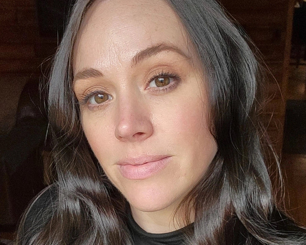 Close-up of a person with long, wavy hair indoors.